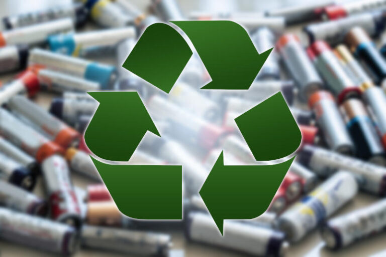 Recycling symbol on a background of used AA battery