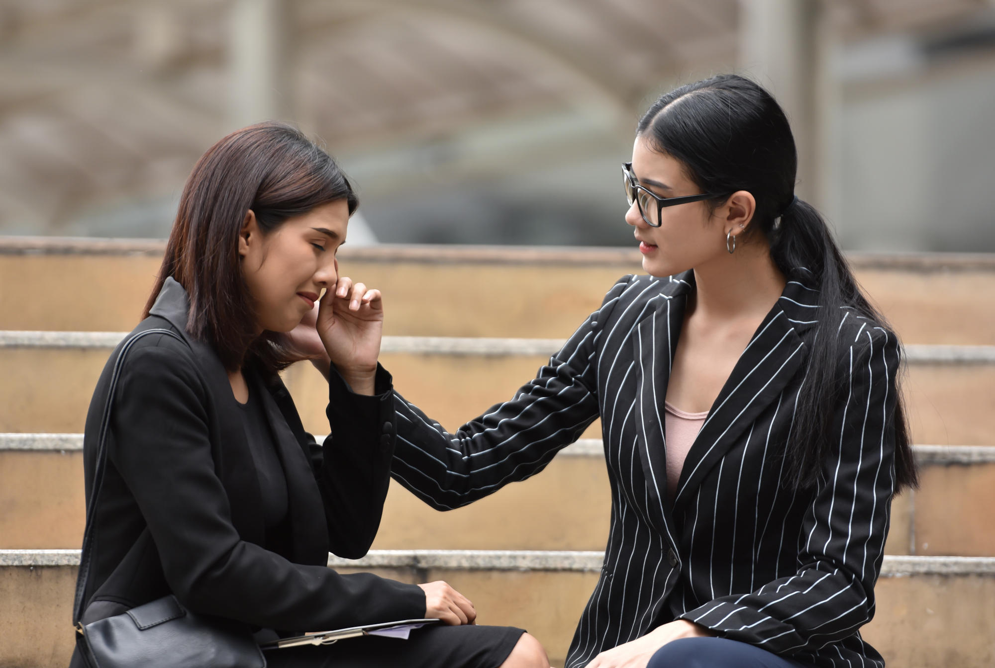 Young Asian Business woman comforting her friend