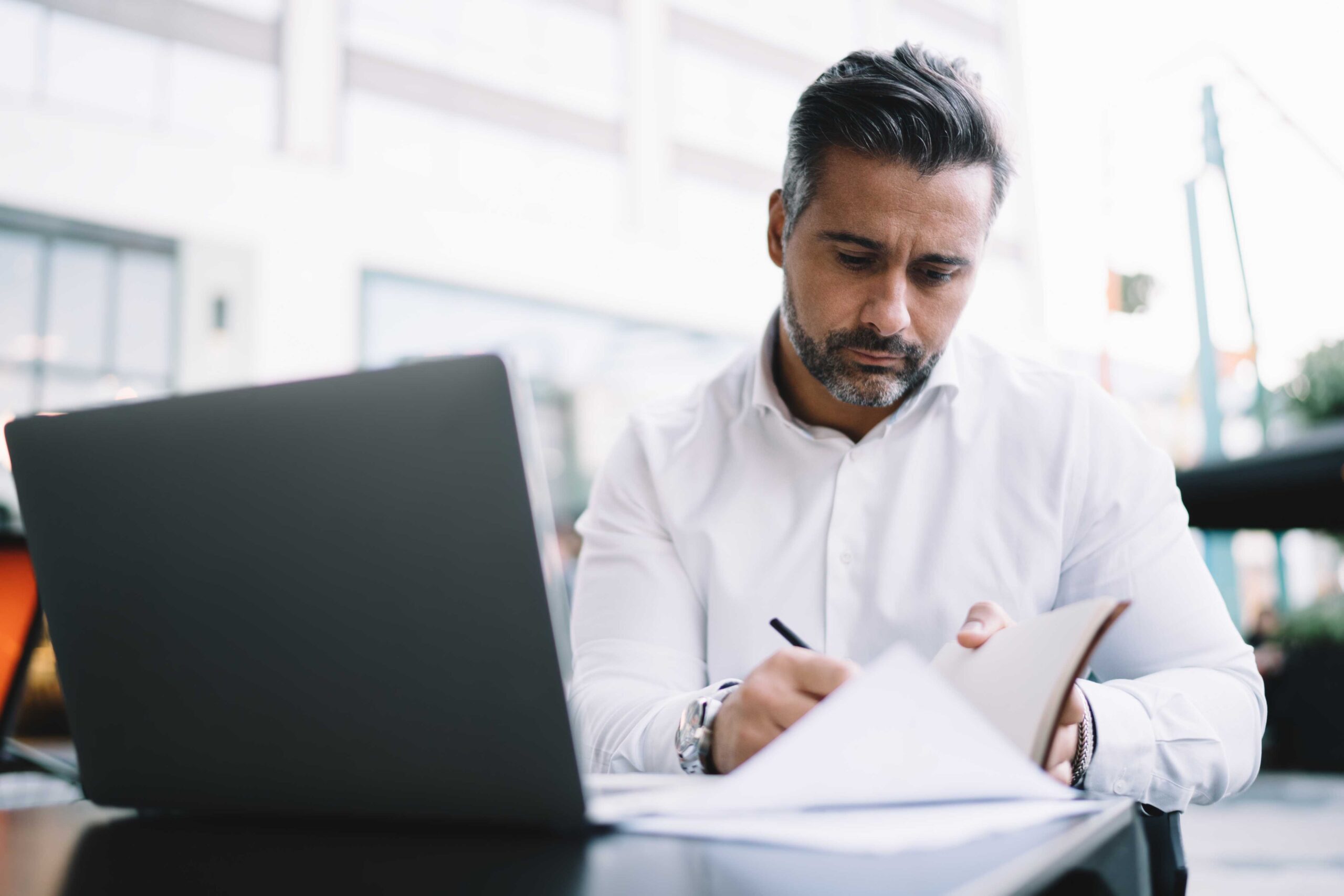 Businessman making informed notes while planning strategy