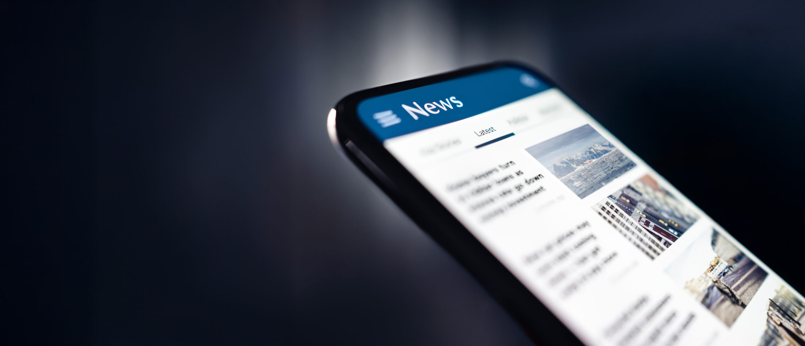 News and press release Headlines and newspaper media in phone Reading articles online Mobile in hand Feed breaking report or business publication - IMD Business School