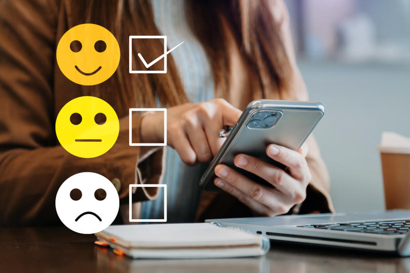 Smart woman use smartphone and tablet choosing happy smile face icon feedback rating and positive customer review experience mental health assessment world mental health day concept