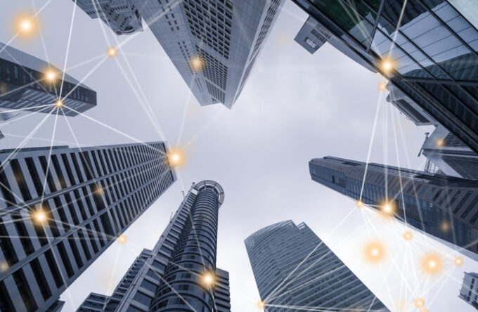 Digital network connection lines of high-rise office buildings skyscrapers architectures in financial district Smart urban city for business and technology concept background in Downtown Singapore