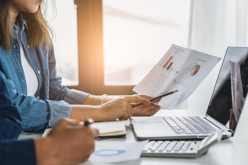 Close up finance advisor pointing into computer screen