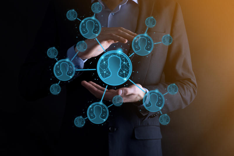 Businessman holding on hand icon of user manwoman low poly polygon style Internet icons interface foreground global network media concept