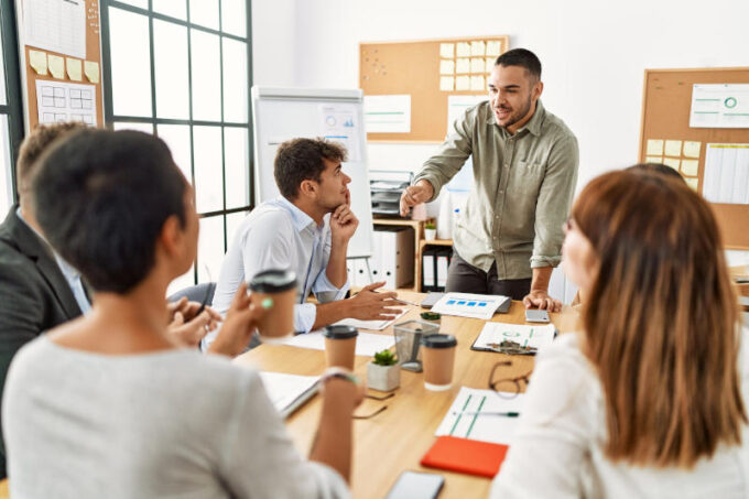 Group of business workers listening boss conference during meeting at the office