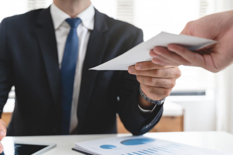 Close up view of office worker receiving salary from boss