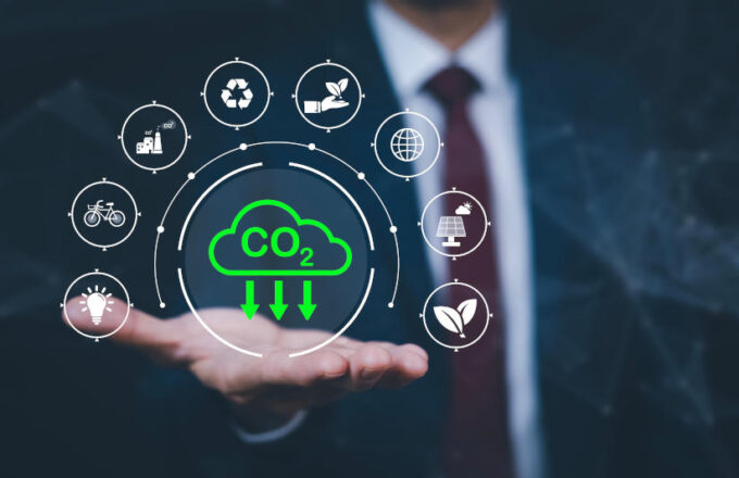 Businessman hand hold recycle symbol connection with virtual modern reduce CO2 emission concept with icons global warming emissions carbon footprint climate change to limit global warming energy