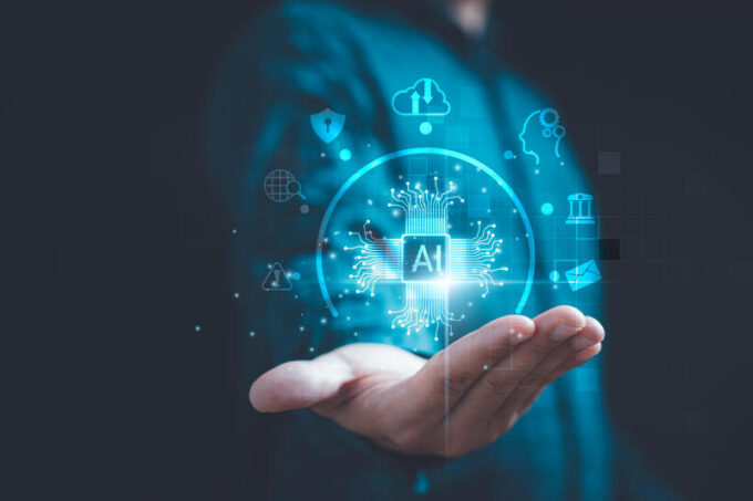 Businessman holding virtual AI or Artificial Intelligence with technology icons include cloud computing chatbot internet banking etc for AI learning management and working behalf of human concept