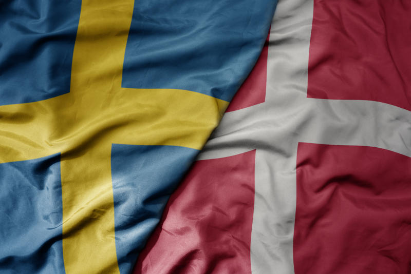big waving national colorful flag of sweden and national flag of denmark