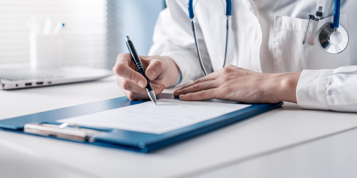 Doctor writing a medical prescription
