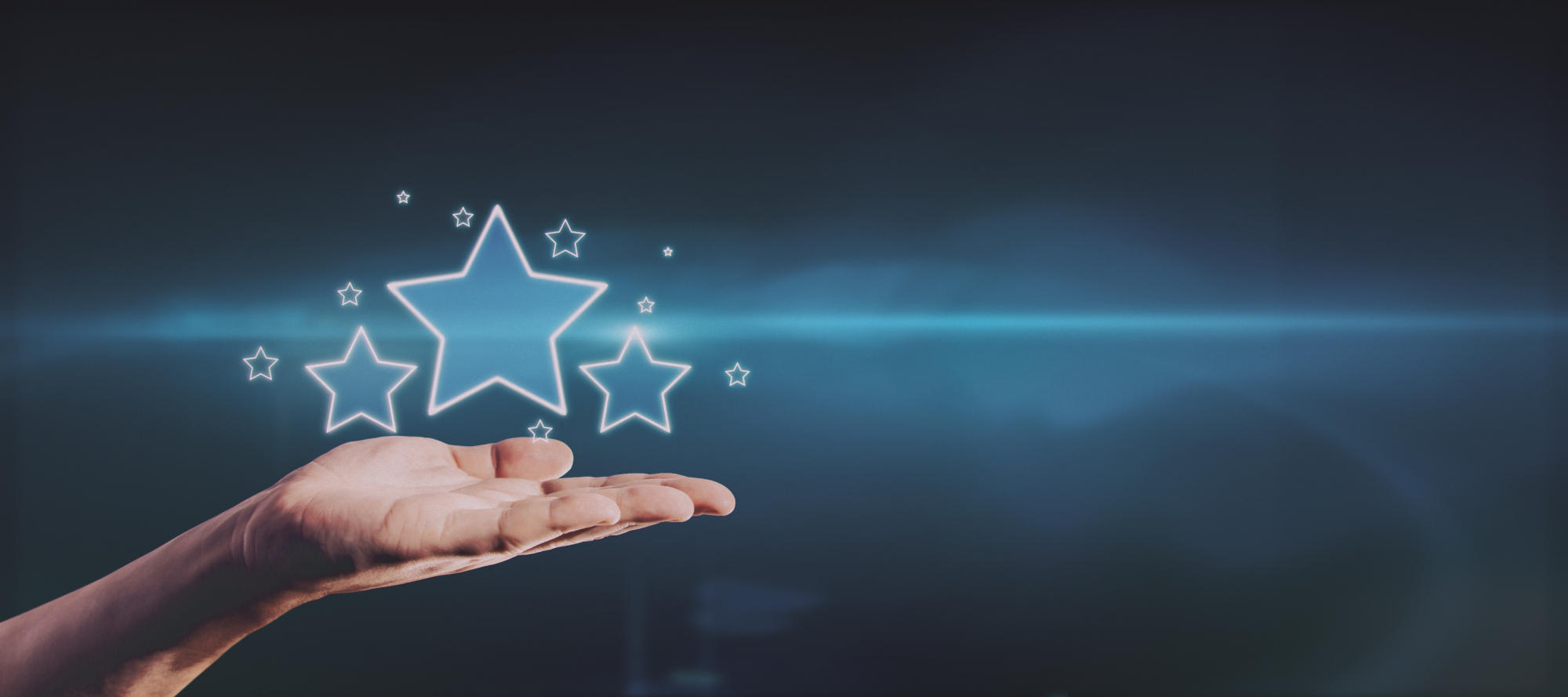 Hand holding glowing stars on blue background with mockup place for your advertisement Customer feedback and ranking concept