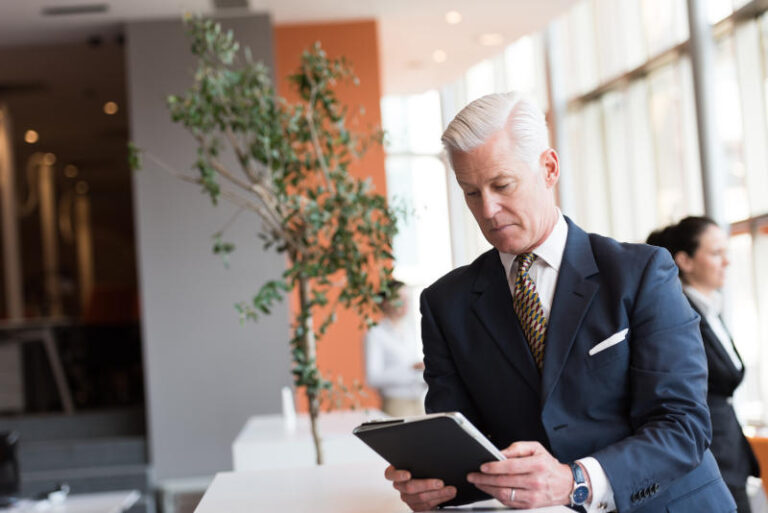 senior business man working on tablet computer