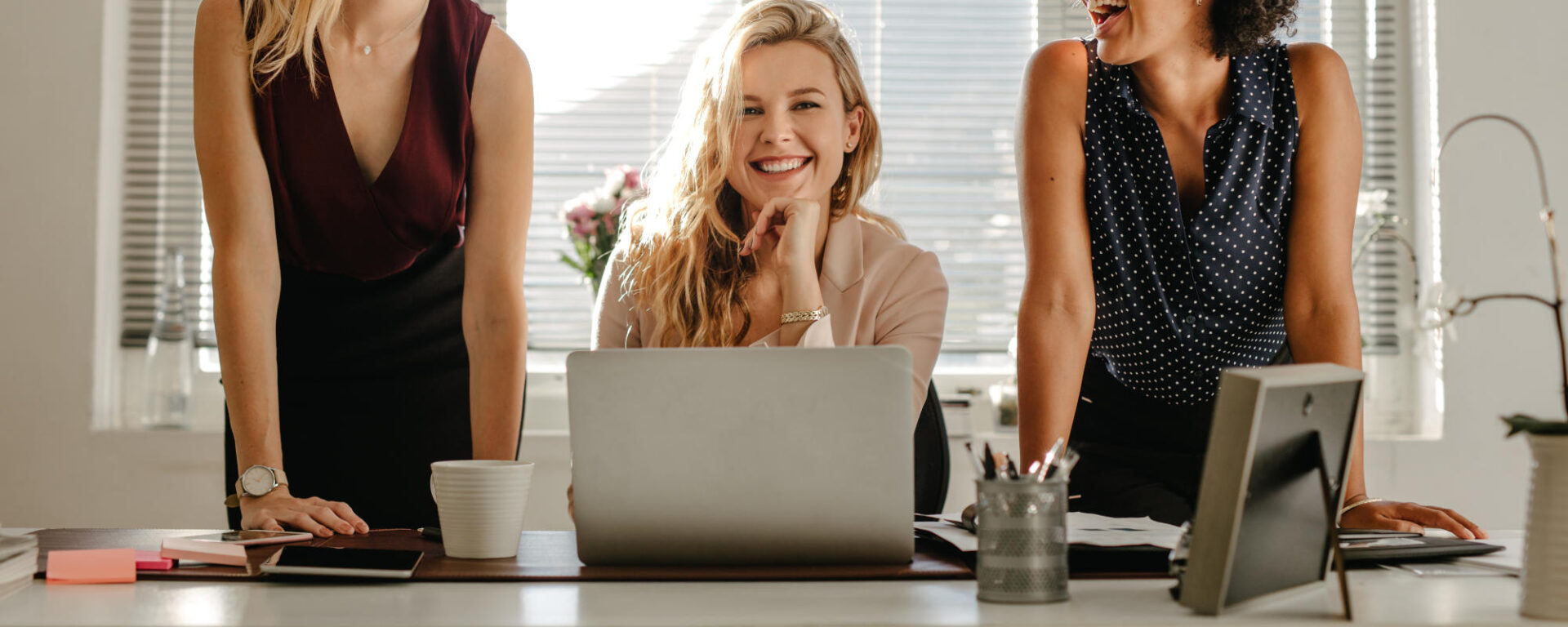 Group of three diverse women in office