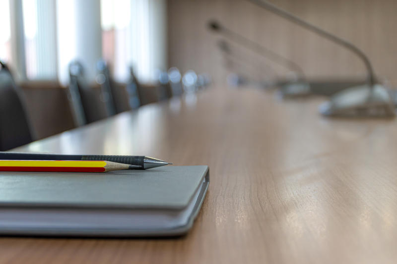Close up microphone on brown table in meeting room