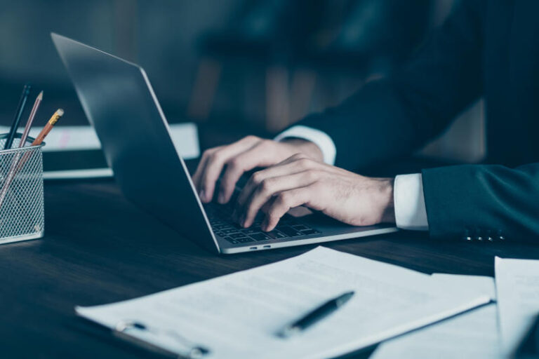 Cropped profile photo of successful business guy freelancer hands arms typing text information notebook table wear black blazer shirt suit costume office indoors