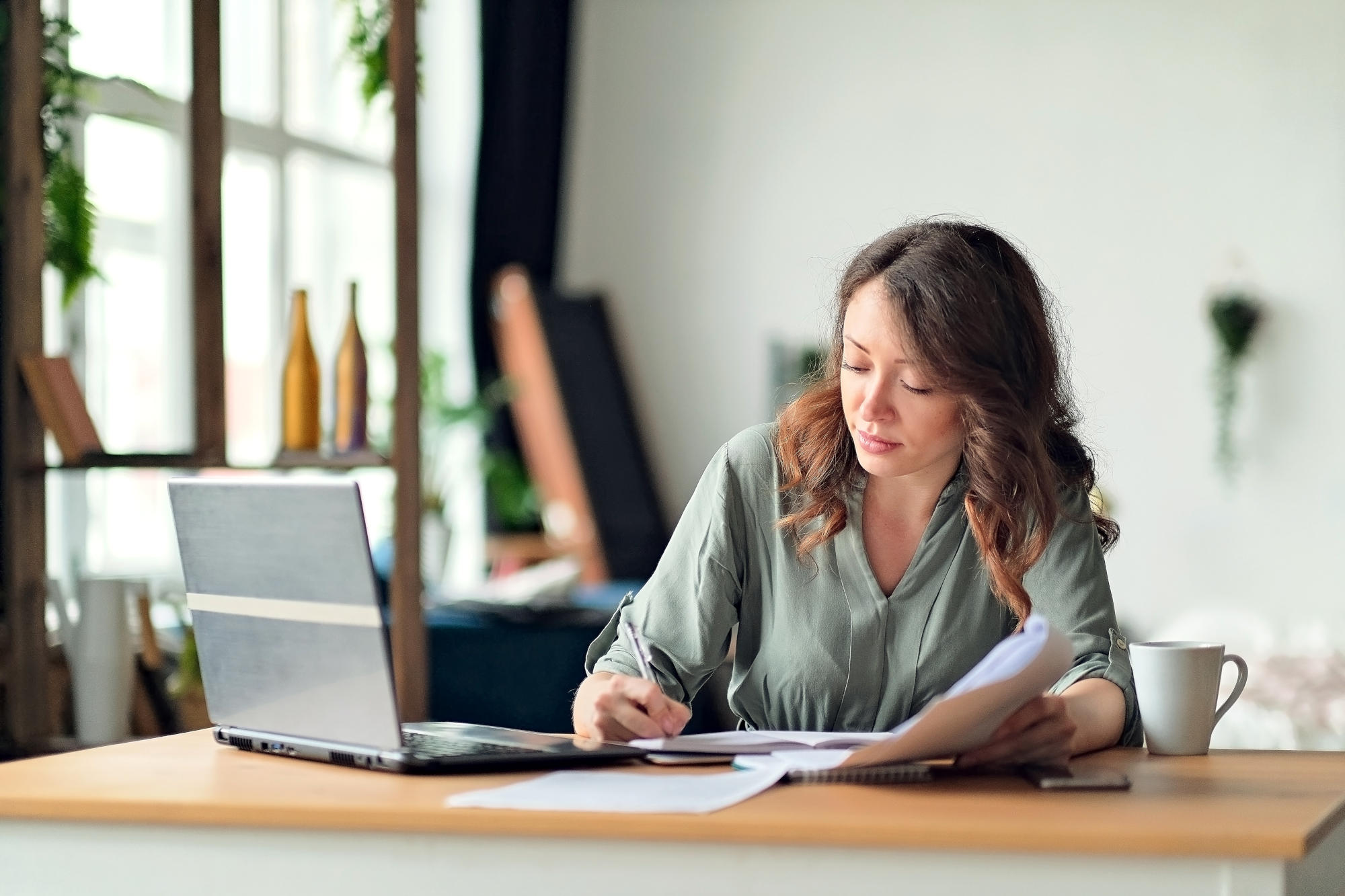 Young woman working from home office Freelancer using laptop and the Internet Workplace in living room