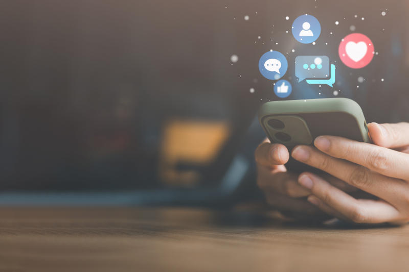 Social media and digital online concept woman using smart phone on sofa at home The concept of living on vacation and playing social media