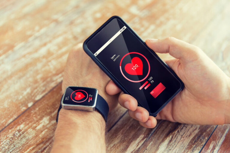 close up of hands with smart phone and watch