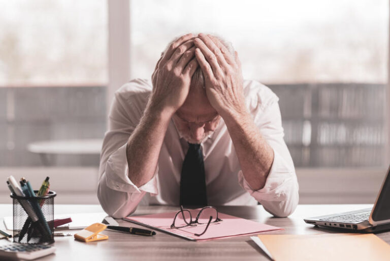 Stressed businessman sitting in office