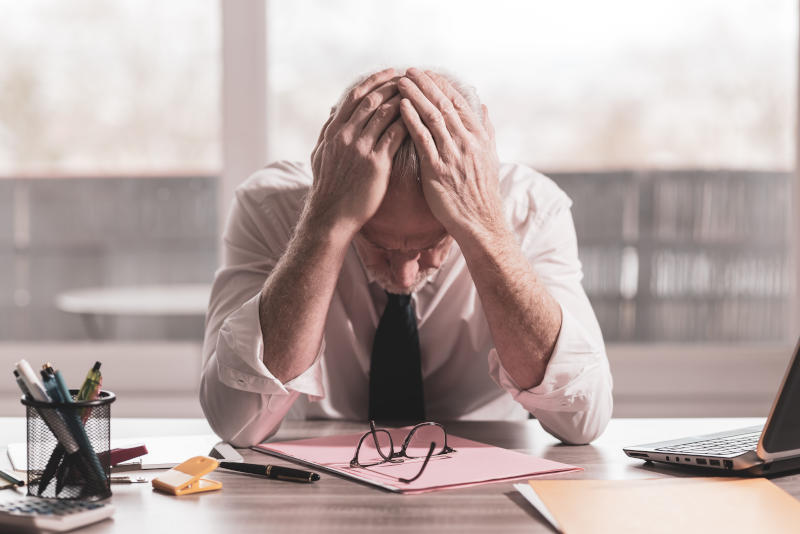 Stressed businessman sitting in office