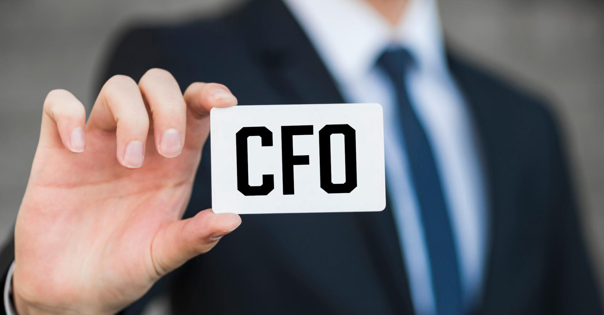 Businessman shows business card with the inscription CFO