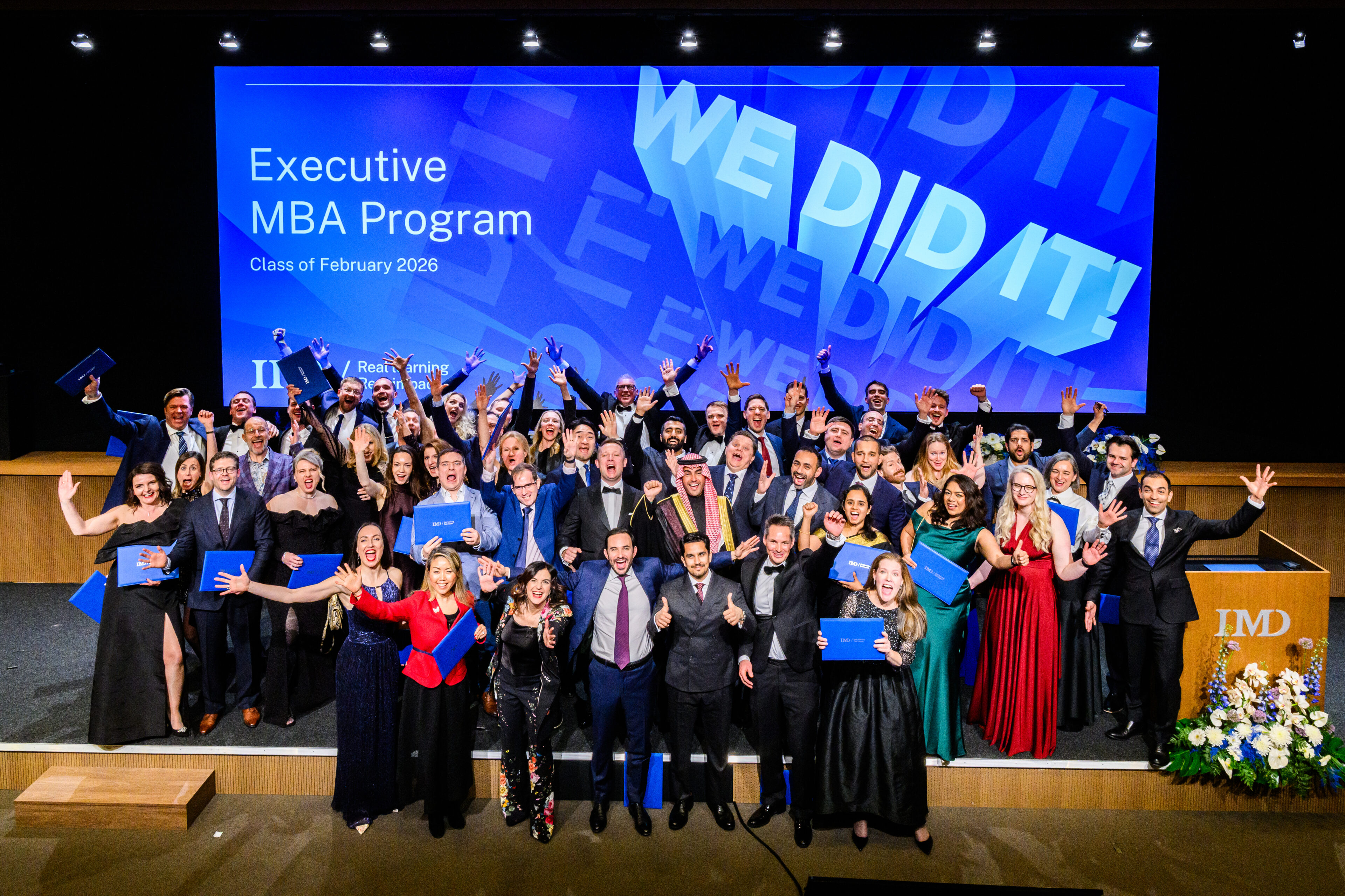 Class of February 2026 celebrates their EMBA graduation with group picture - IMD Business School
