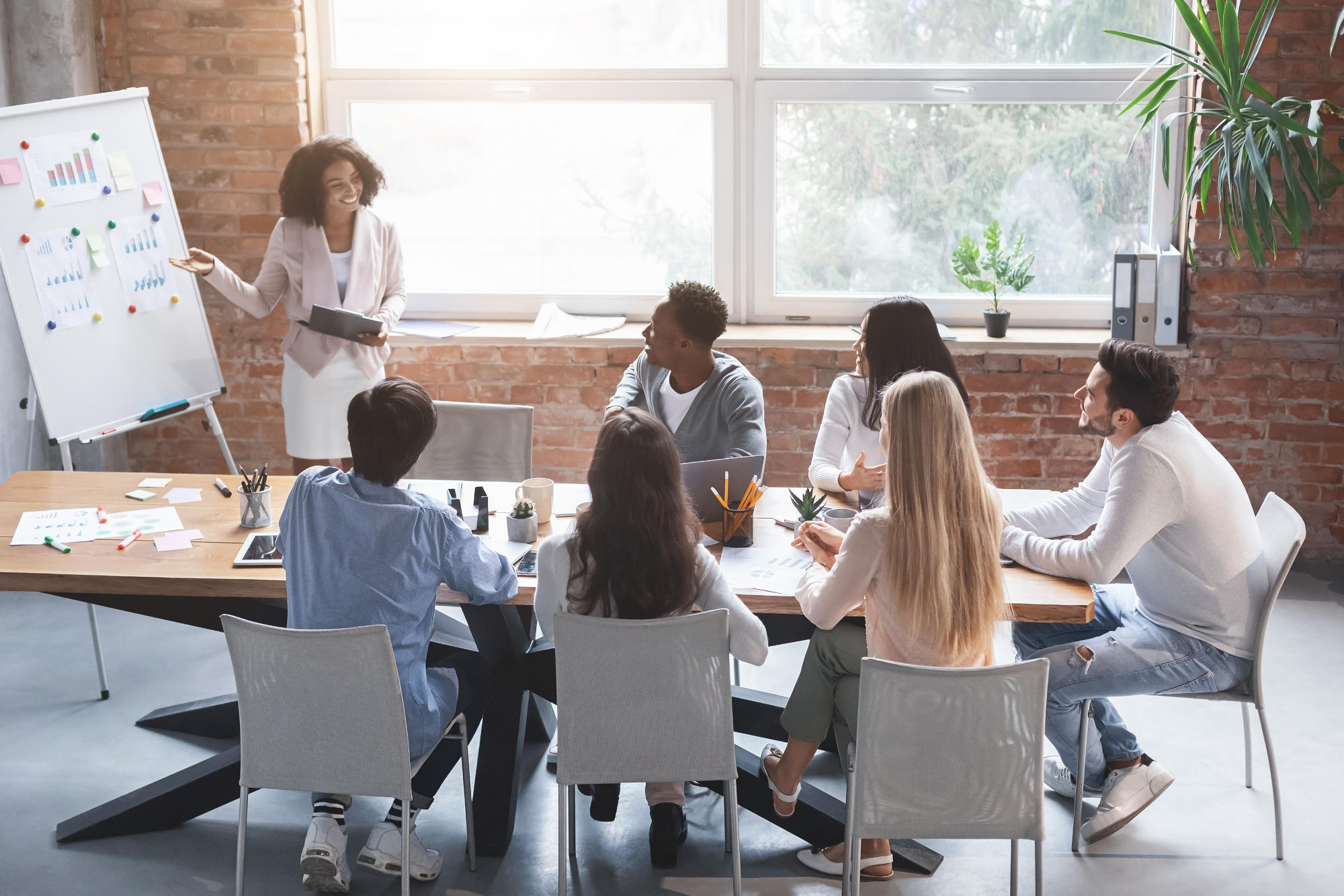 Black employee making presentation during morning briefing