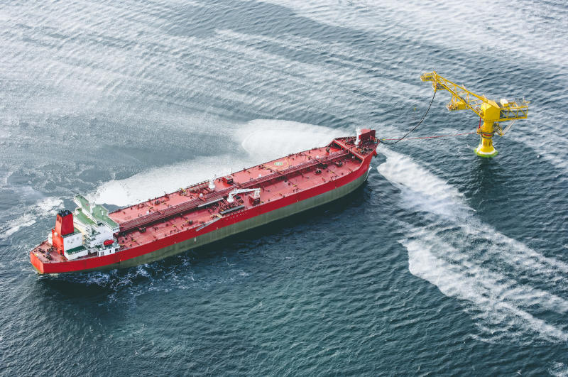 An oil tanker pumps oil to a special offshore oil receiver for the De Castries oil terminal