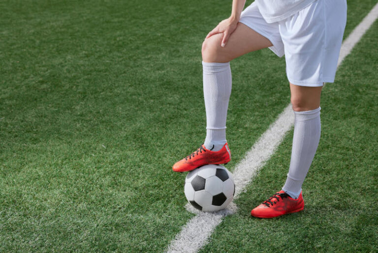 sports girl football player with a soccer ball on the soccer field the concept of professional womens football