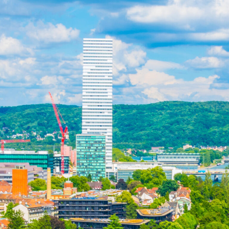 Riverside of Rhine dominated by the Roche tower in Switzerland - square