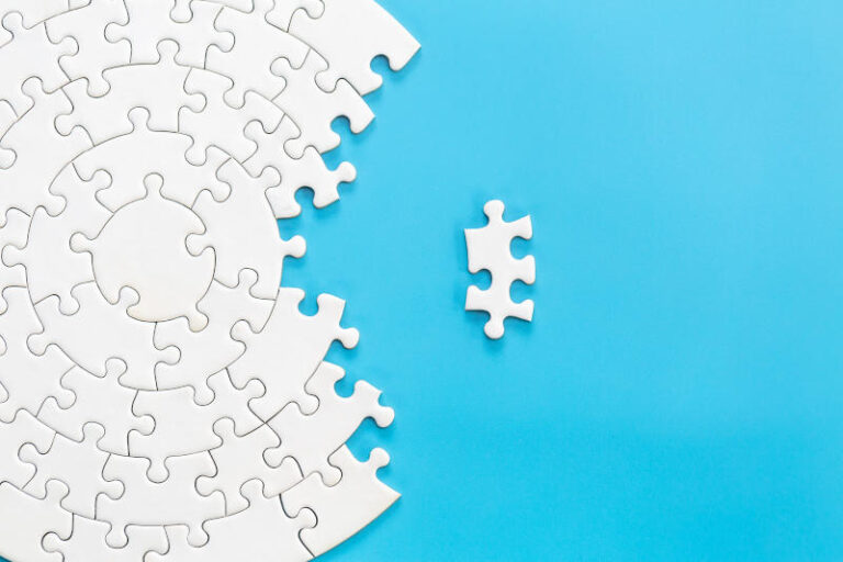 White jigsaw puzzle pieces on a blue background Problem solving
