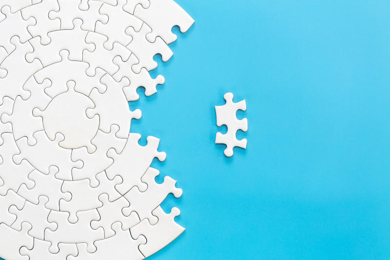 White jigsaw puzzle pieces on a blue background Problem solving