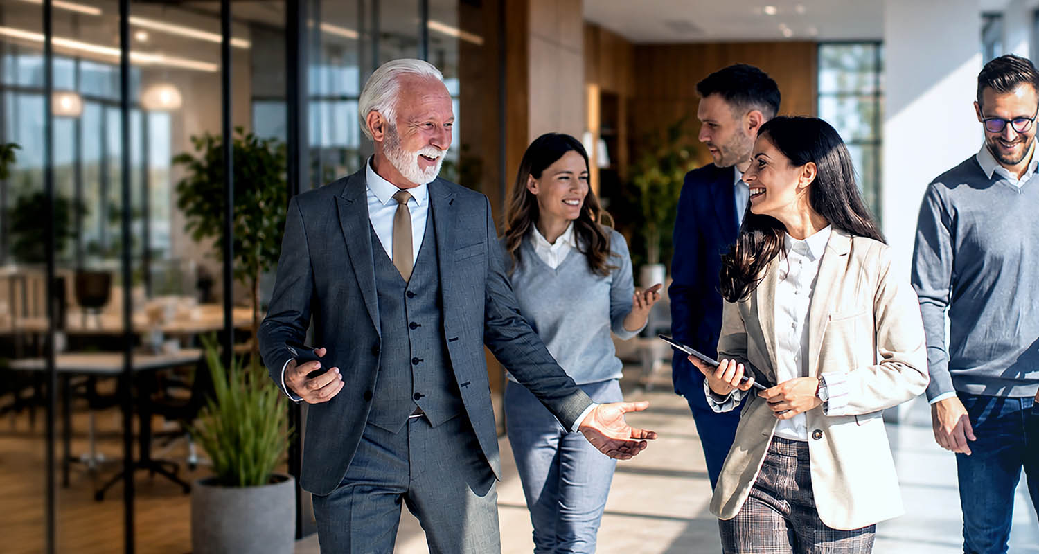 Family Business team collaborating in a modern office environment, embodying professional growth and organizational leadership - IMD Business School