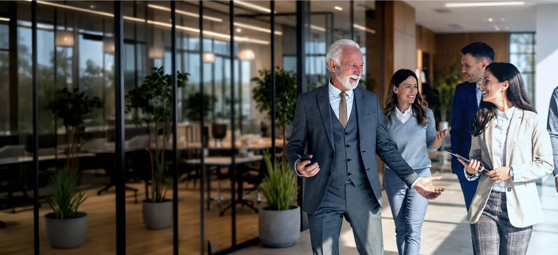 Family Business team collaborating in a modern office environment, embodying professional growth and organizational leadership - IMD Business School