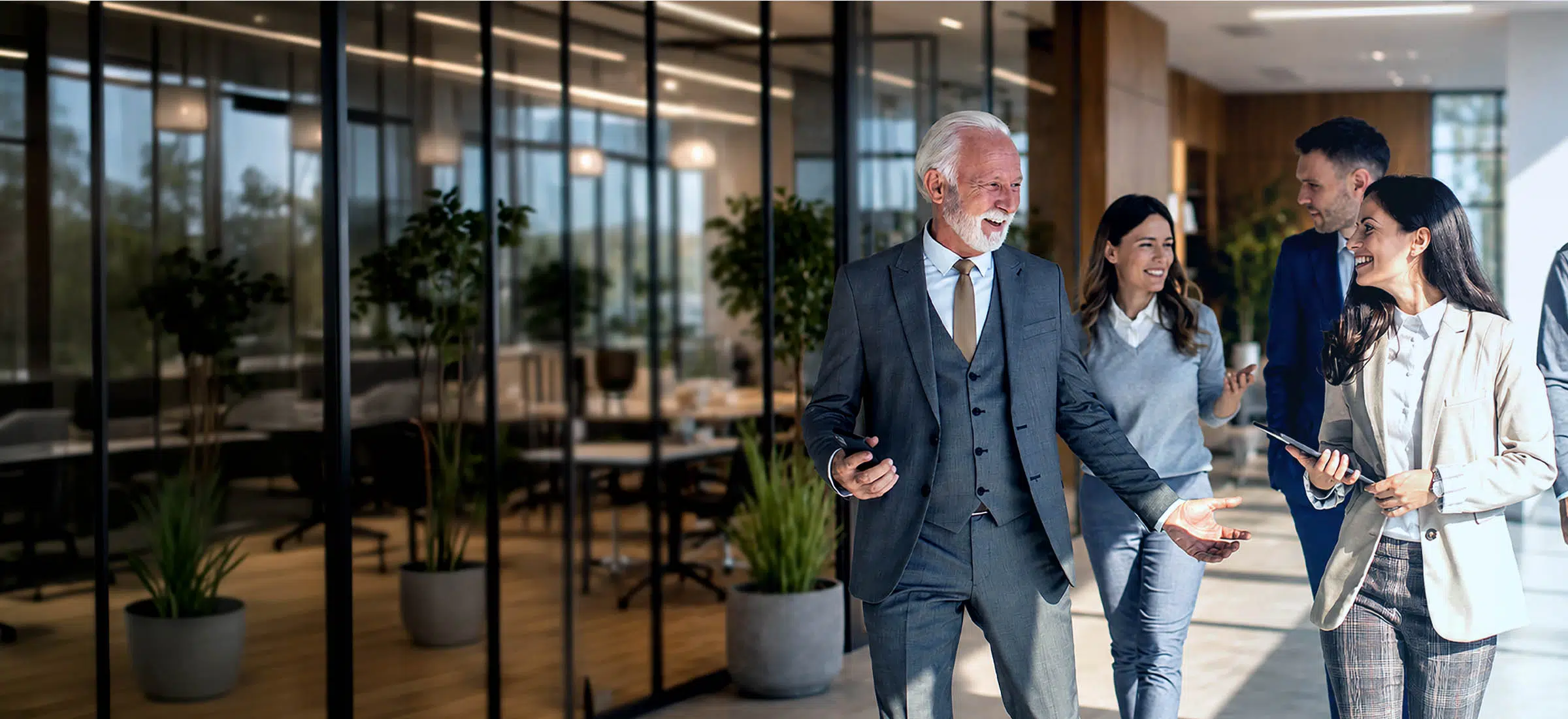 Family Business team collaborating in a modern office environment, embodying professional growth and organizational leadership - IMD Business School