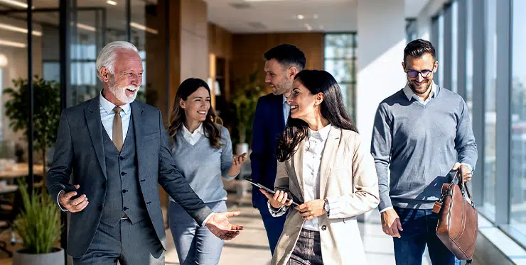Leading Family Business - a group of executives talking in a modern setting - IMD Business School