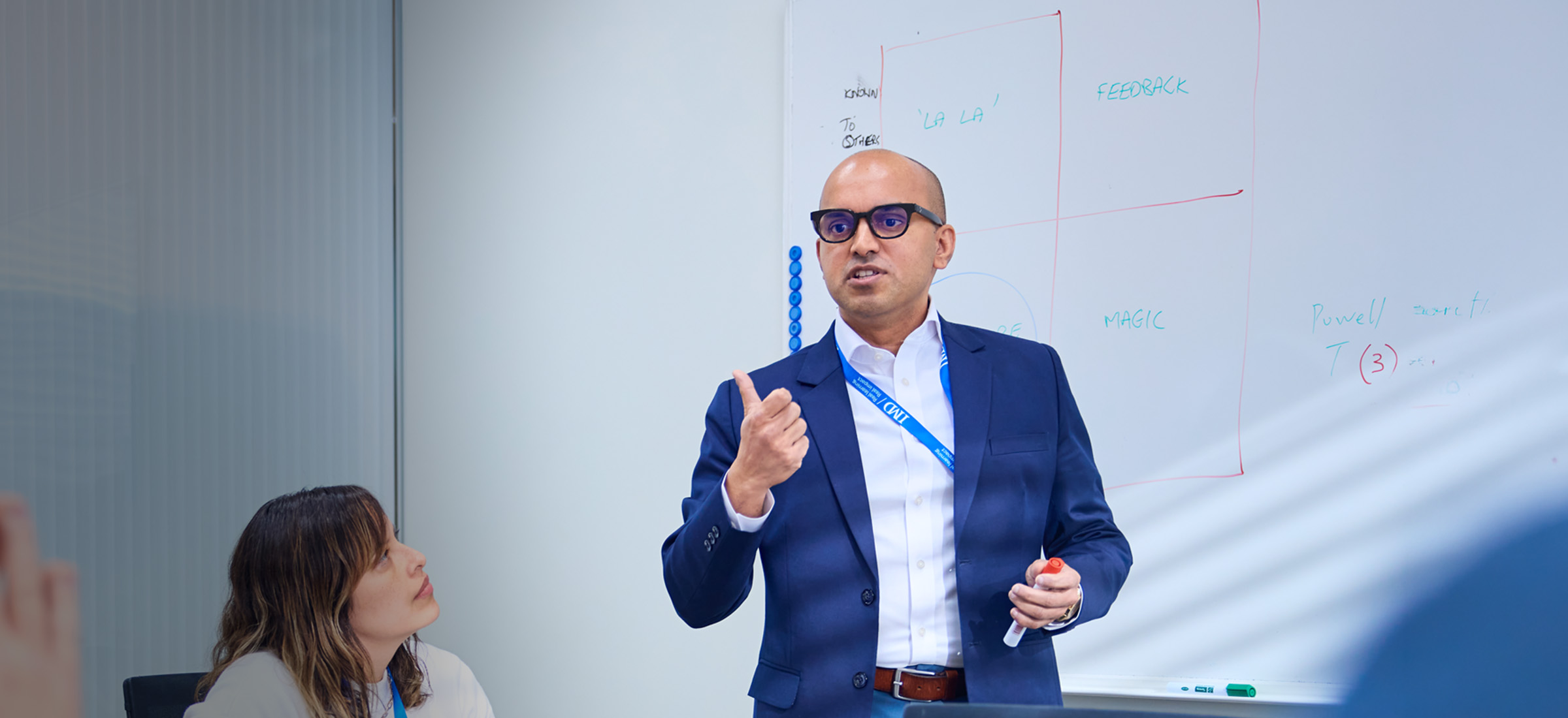 IMD EMBA participants working in a small group - IMD Business School