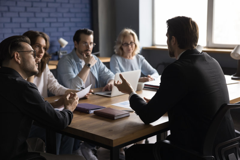 Company executive man to employees on planning meeting