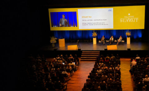Audience attending a Salzburg Summit discussion featuring David Bach and Justin Trudeau on stage