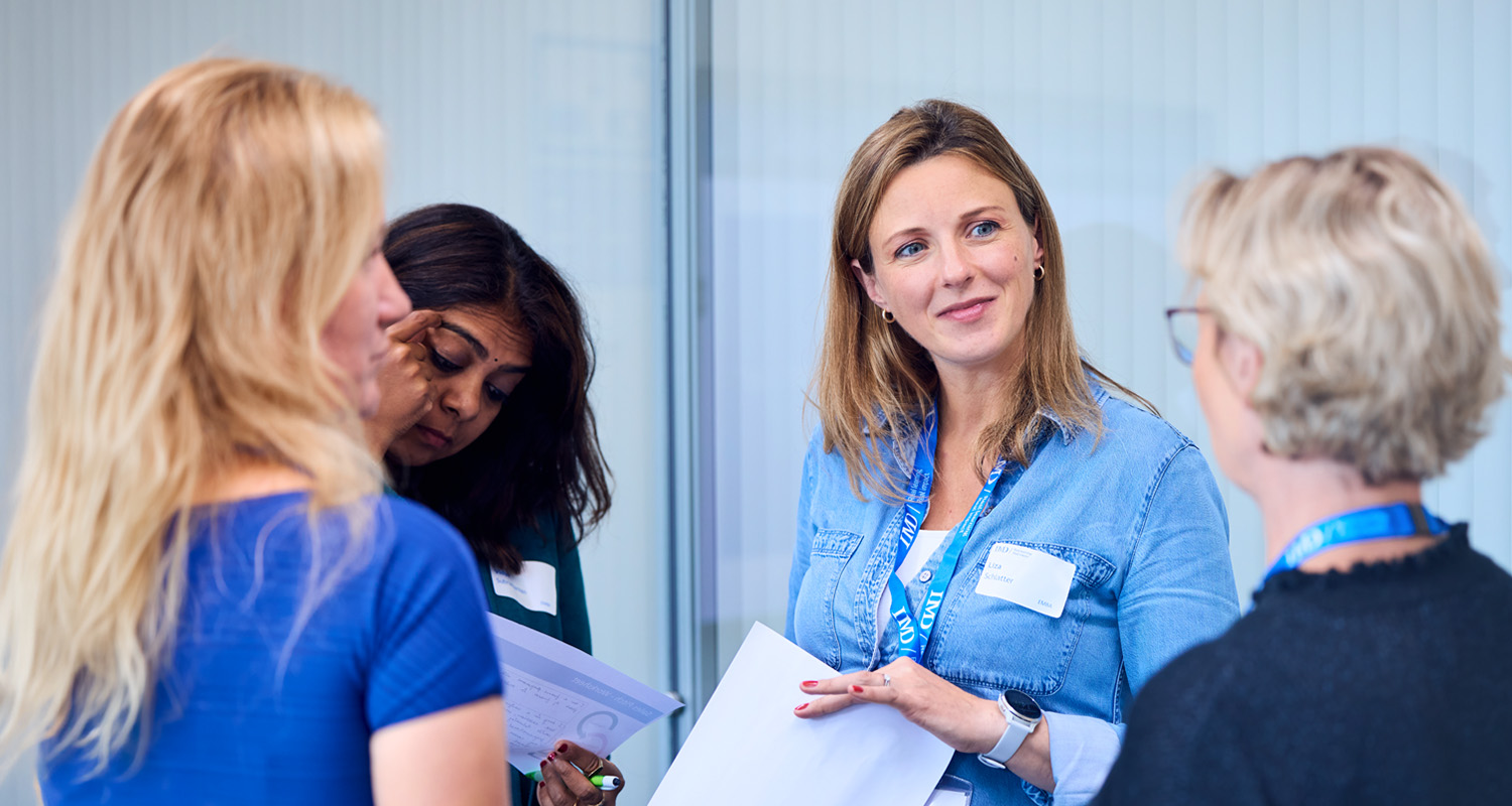 IMD-EMBA-group of women participants discussing during a workshop - IMD Business School