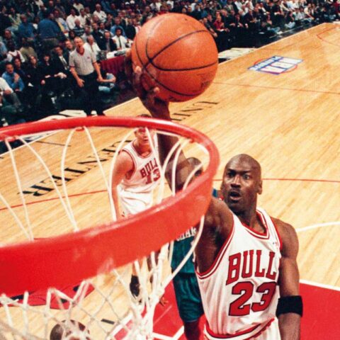 Michael Jordan playing for the Chicago Bulls, credited Sporting News via Getty Images.