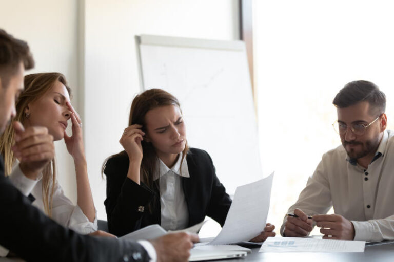 Frustrated colleagues feel stressed because of paperwork problems