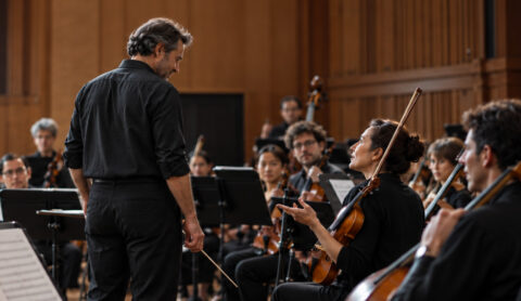 Conductor leading an orchestra